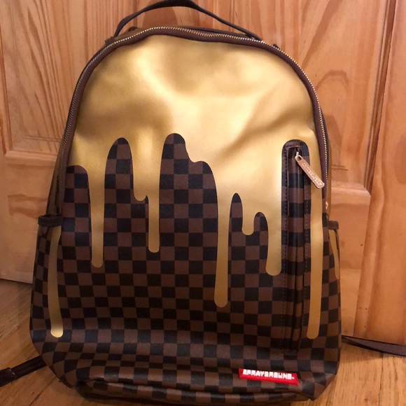 sprayground gold drip backpack
